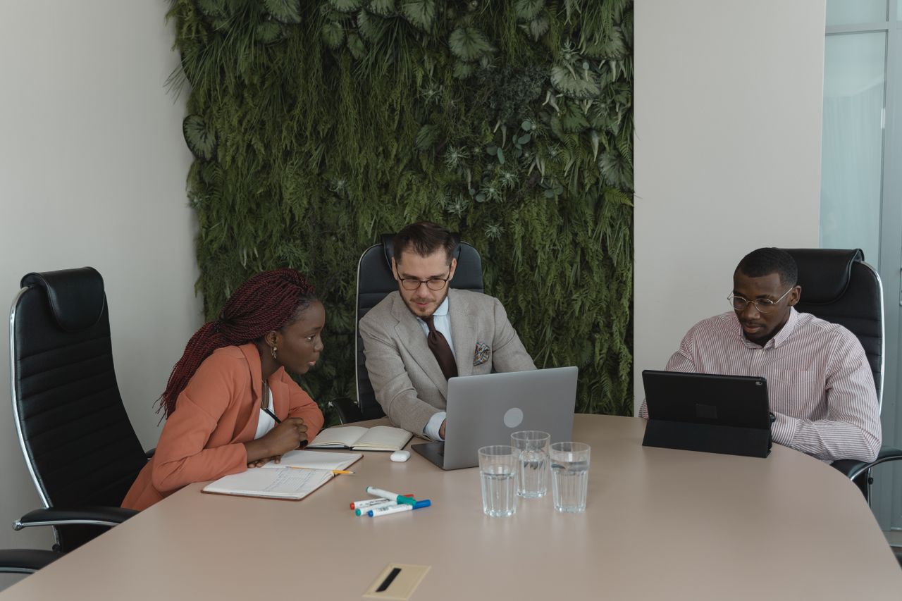 Professional team discussing operational plans and sustainability initiatives in a real office