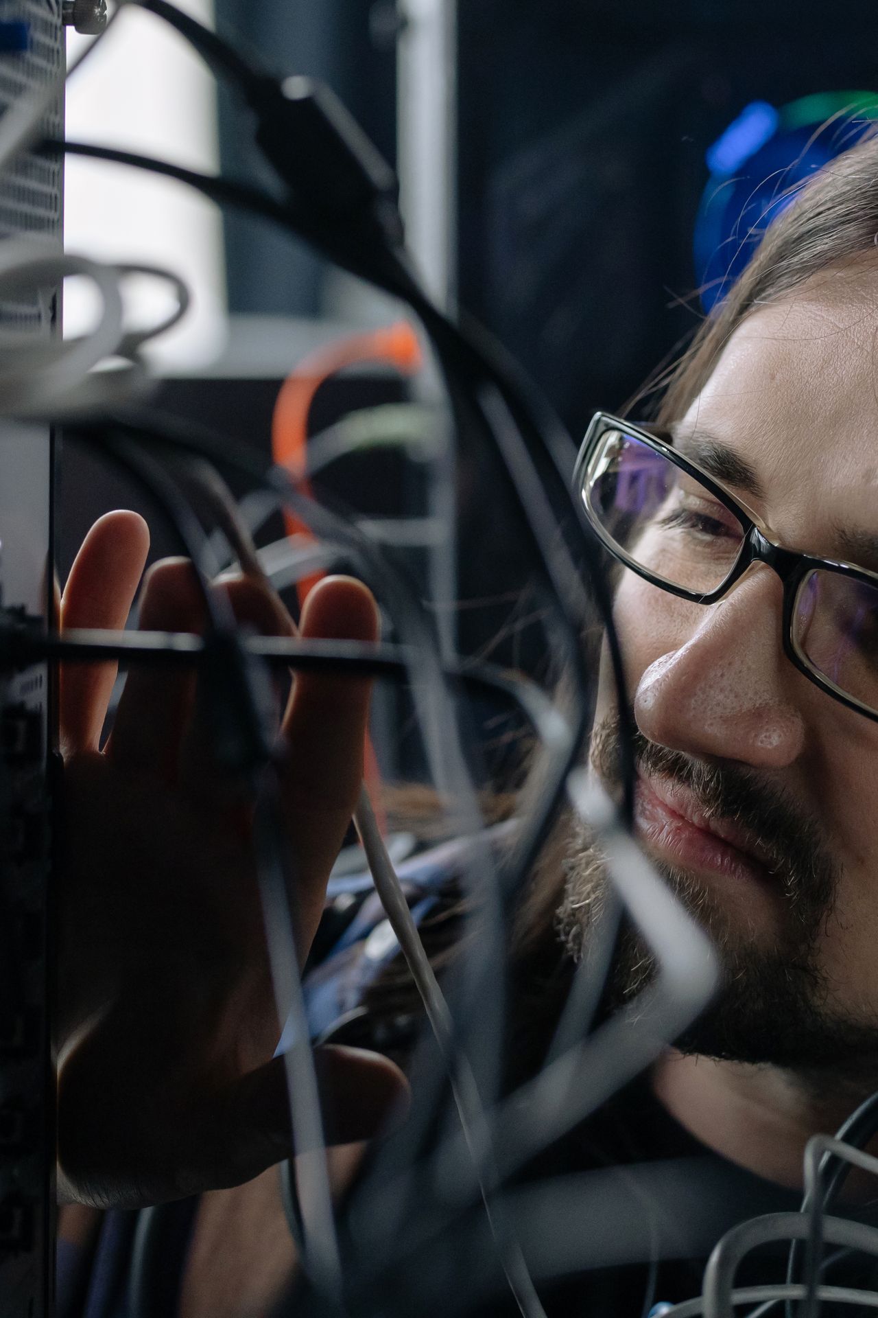 IT specialist handling network cables in a real server room