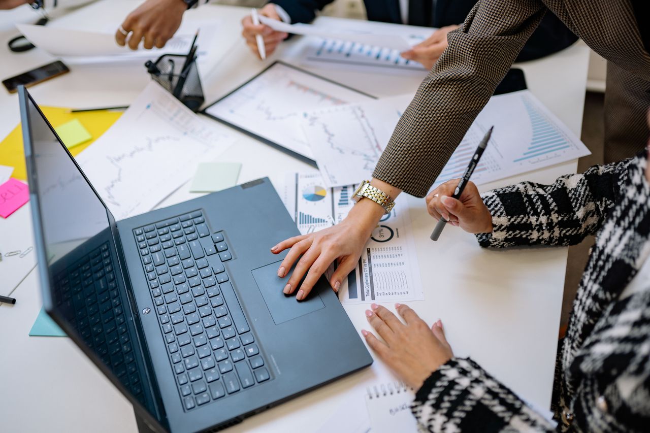 Business professionals reviewing financial and operational risk information in a real office meeting